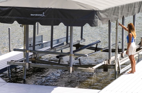 UltraBunks pivoting aluminum and poly bunks mounted on load-bearing channels for boat lifts